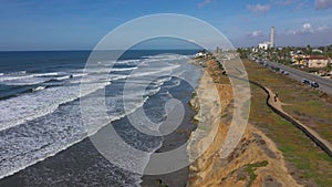 Aerial Carlsbad California surf shore cliff traffic 4K