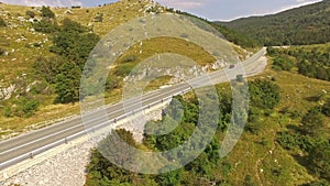 Aerial: Cars Driving On Serpentine Mountain Road At Summer