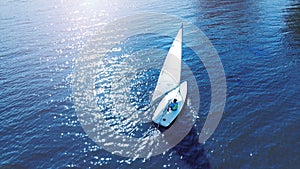 Aerial. Catboat yacht on a water.