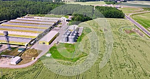Aerial circular flight around silos and agro-industrial livestock complex on agro-processing and manufacturing plant with modern g