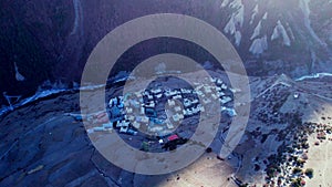 Aerial circular view fly over Khangshar village houses on mountain valley. Manang district. Tilicho base camp trail