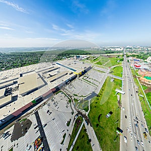 Aerial city view with crossroads and roads, houses buildings. Copter shot. Panoramic image.