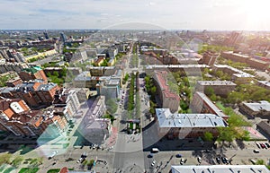 Aerial city view with crossroads and roads, houses buildings. Copter shot. Panoramic image.