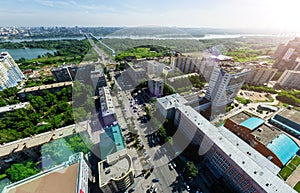 Aerial city view with crossroads and roads, houses buildings. Copter shot. Panoramic image.