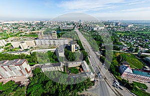 Aerial city view with crossroads and roads, houses buildings. Copter shot. Panoramic image.