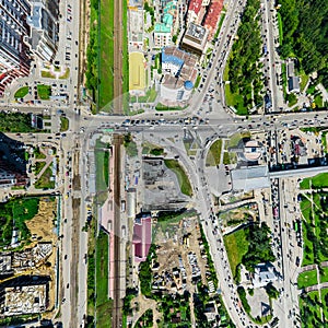 Aerial city view with crossroads and roads, houses buildings. Copter shot. Panoramic image.