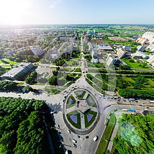 Aerial city view with crossroads and roads, houses buildings. Copter shot. Panoramic image.