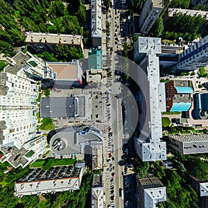 Aerial city view with crossroads and roads, houses buildings. Copter shot. Panoramic image.