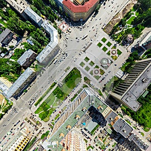 Aerial city view with crossroads and roads, houses buildings. Copter shot. Panoramic image.