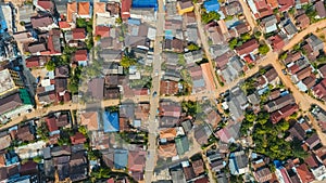 Aerial city view with crossroads and roads, houses, buildings, parks and parking lots, bridges. Copter shot.