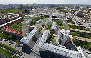 Aerial city view with crossroads and roads, houses buildings. Copter shot. Panoramic image.