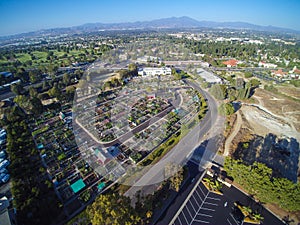 Aerial city view with roads, buildings, parks and parking lots.