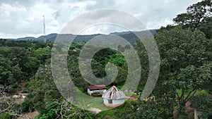 Aerial city view of a small house in green field Jos, Nigeria from high above