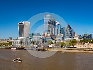 Aerial cityscape of the Thames river on a sunny day with the City Financial district skyscrapers
