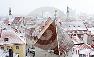 Aerial cityscape view of Tallinn Old Town on winter day. Red rooftops from tiles, Golden Cockerel weathervane, Town Hall spire,