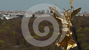 AERIAL: Close Up Circling around Berlin Victory Column Golden Statue Victoria in Beautiful Sunlight