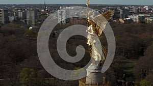 AERIAL: Close Up Circling around Berlin Victory Column Golden Statue Victoria in Beautiful Sunlight and Berlin, Germany