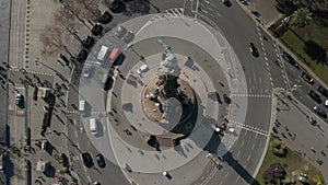 AERIAL: Close up of Columbus Monument in Barcelona, Spain on Beautiful Sunny Day with busy car traffic on Roundabout
