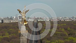 AERIAL: Close Up Dolly of Berlin Victory Column Golden Statue Victoria in Beautiful Sunlight and Berlin, Germany City