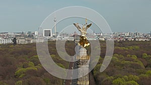 AERIAL: Close Up Dolly of Berlin Victory Column Golden Statue Victoria in Beautiful Sunlight and Berlin, Germany City