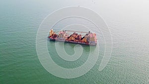 Aerial close-up of a gravel salvage ship near the sea, sand mining ship