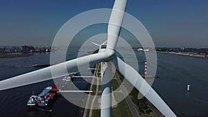 Aerial close-up view of rotating wind turbines in the port of rotterdam.