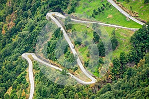 Aerial close-up view of a zig-zag winding road going up a steep slope near Geiranger, Norway