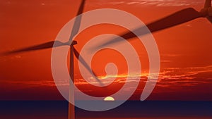 Aerial close-up of windmills at sunset, rotating under the power of the wind and generating renewable energy in a low