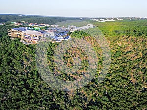 Aerial colorful restaurant and vacation homes in lush green fore