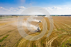 Aerial: The combine harvester on the wheat field