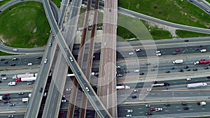 Aerial of complex road interchange, vehicles crisscrossing, symbol of connectivity. City motion: Aerial footage of busy