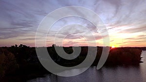 Aerial crane view of a dramatic sunset over the river