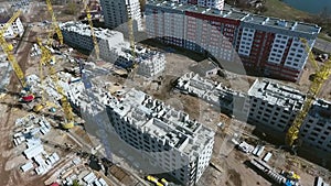 Aerial of cranes on construction site of multistory buildings