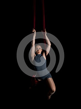 Aerial dancer woman isolated on black