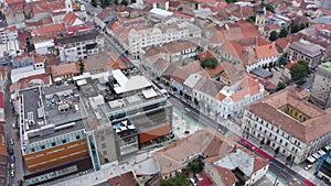 Aerial daytime view above downtown Cluj, Romania. Historical buildings and traffic. Ferdinand street