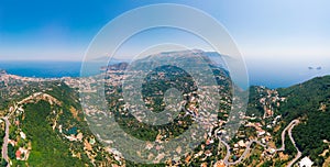 Aerial daytime view of Sorrento coast, Italy. Streets of city with hotels and restaurants are located on rocky seashore, mountains