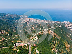 Aerial daytime view of Sorrento coast, Italy. Streets of city with hotels and restaurants are located on rocky seashore, mountains