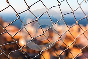 Aerial defocused view of Marseilles behind wire mesh fences
