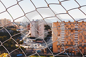 Aerial defocused view of Marseilles behind wire mesh fences