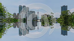 Aerial descending shot of high rise buildings in modern metropolis. Revealing trees in park. Colombo, Sri Lanka