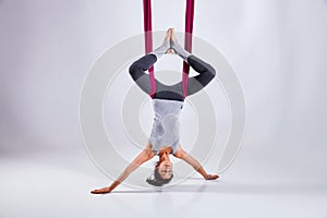 Aerial different inversion antigravity yoga in a hammock