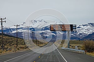 AERIAL: Digital sign above the empty highway signalling three exits are closed.