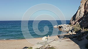 Aerial Dolly along Old Abandoned Factory Building at Beach on Milos Island, Greece