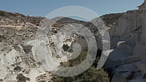 Aerial Dolly Through Beautiful Sarakiniko Lunar Volcanic Canyon with Dry Desert Surrounding in Milos Island, Greece