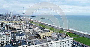 Aerial dolly view of the town of Brighton and Hove towards the beach