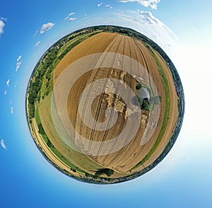 Aerial drone 360 degree panoramic view on agricultural landscape with wheat field, green water pond, meadows and forest