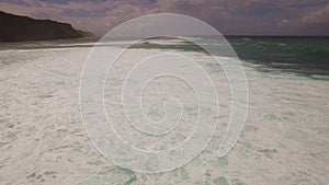Aerial drone 4k footage of ocean waves breaking before the shore. Bali, Indonesia
