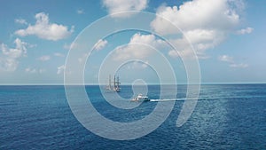 Aerial drone approaching a white ship and a boat in the sea Bridgetown, Barbados