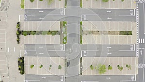 Aerial drone, asphalt and empty parking lot in city for driving, stop signs and lines in road above. Top view of street