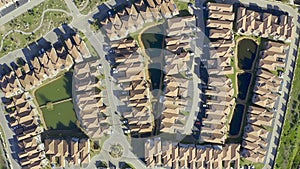 Aerial drone, city and buildings of neighborhood with natural greenery and industrial architecture. Top view of land